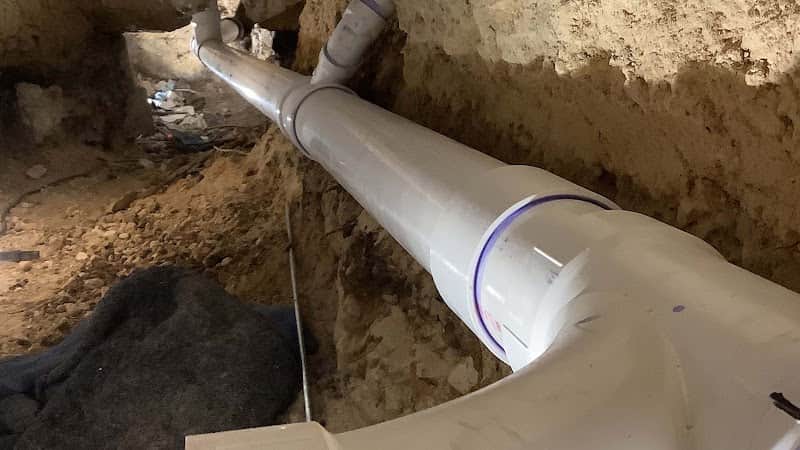 Licensed plumber performing sewer line inspection