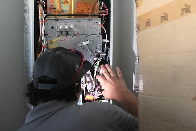 Licensed plumber performing sewer line inspection