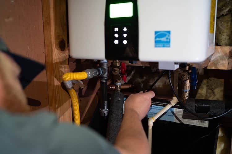 Licensed plumber performing sewer line inspection