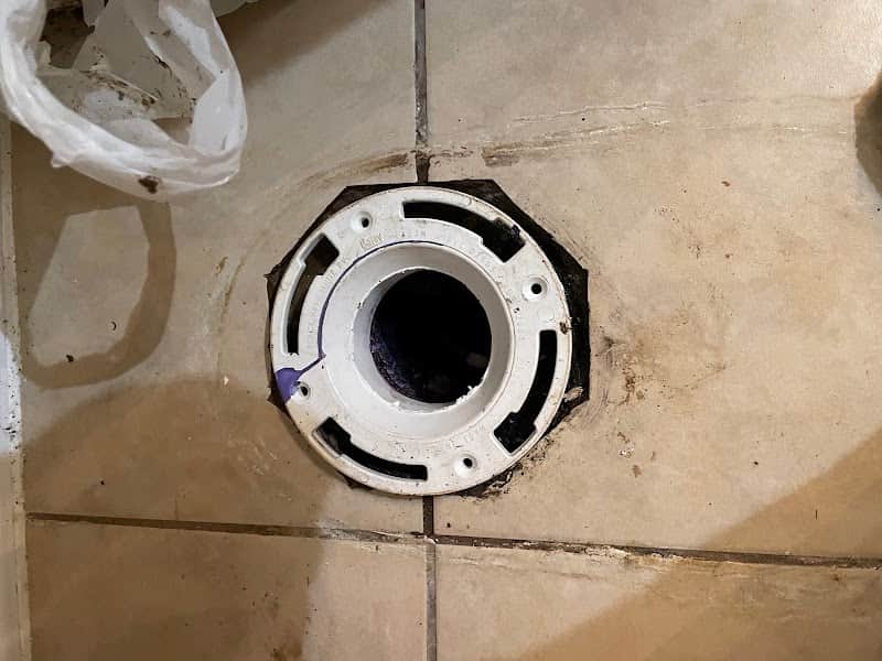 Licensed plumber performing sewer line inspection