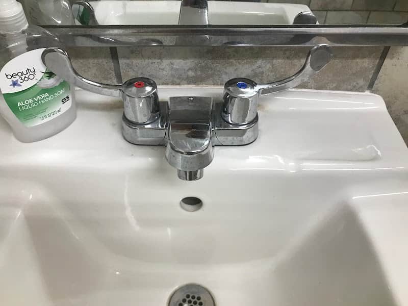 Licensed plumber performing sewer line inspection