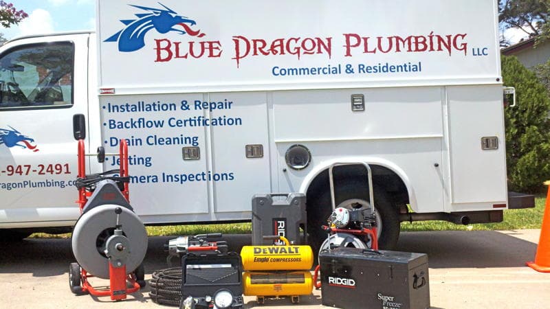 Licensed plumber performing sewer line inspection