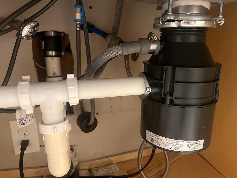 Licensed plumber performing sewer line inspection