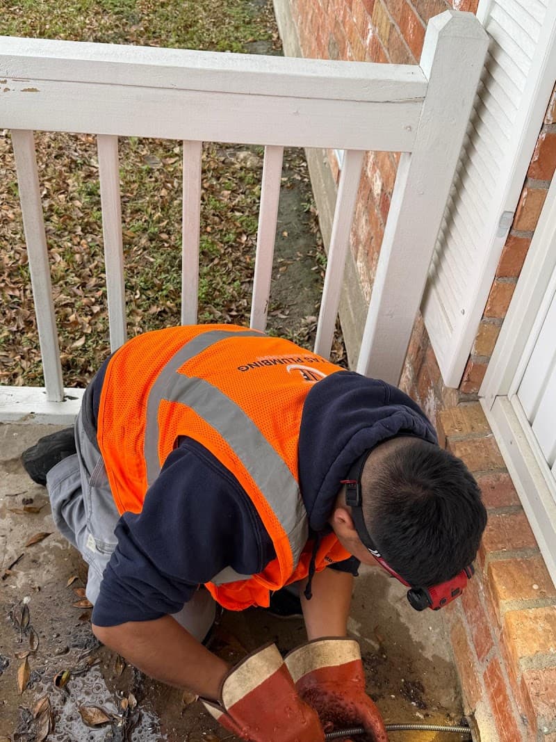 Licensed plumber performing sewer line inspection